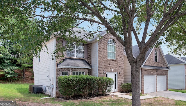 view of front of house with an attached garage, concrete driveway, brick siding, and central AC unit