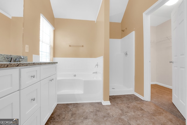 bathroom with vaulted ceiling, shower with separate bathtub, tile patterned flooring, and vanity