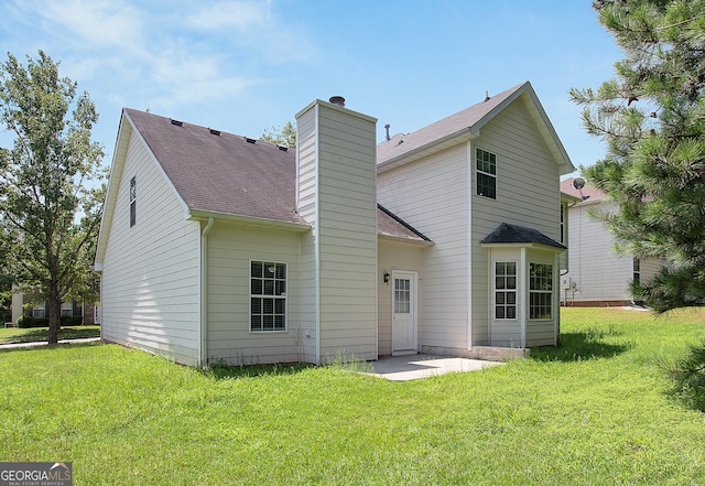 back of house with a lawn