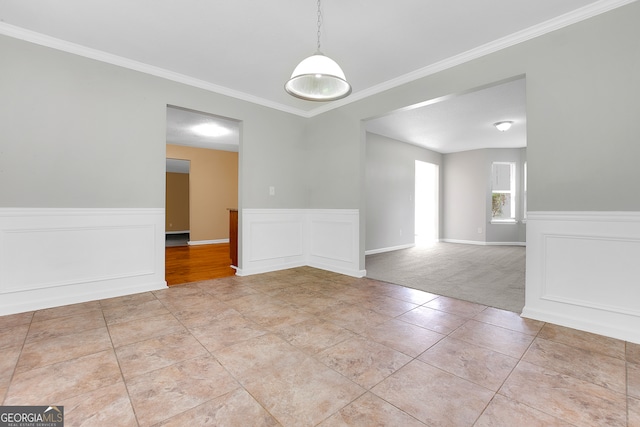 unfurnished room featuring ornamental molding and light colored carpet