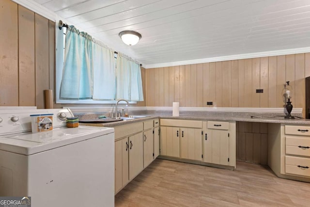 laundry area featuring wooden walls, light wood-type flooring, and washer / dryer