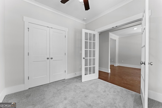 unfurnished bedroom featuring ceiling fan, ornamental molding, a closet, french doors, and carpet flooring