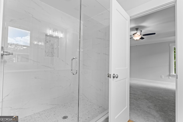 bathroom featuring ceiling fan and a shower with door