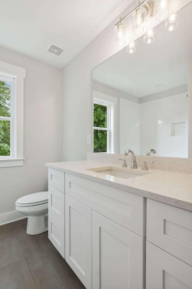 bathroom with tile patterned floors, vanity, and toilet