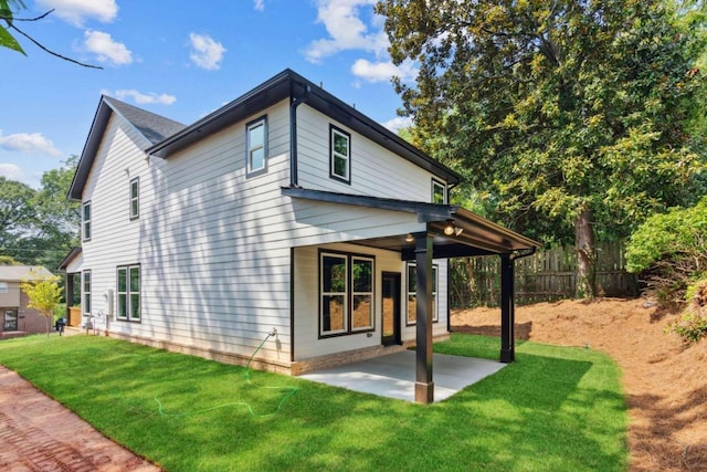 rear view of property with a patio area and a yard