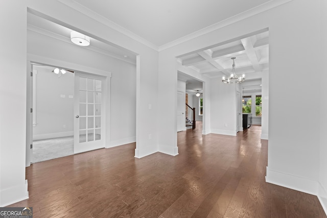 spare room with coffered ceiling, crown molding, beamed ceiling, ceiling fan with notable chandelier, and hardwood / wood-style flooring