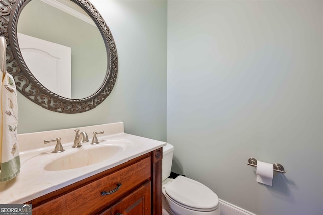 bathroom with toilet and vanity