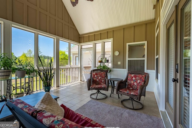 sunroom / solarium with ceiling fan and vaulted ceiling