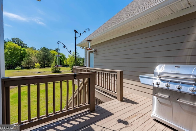 deck featuring a lawn and a grill