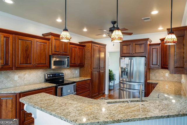 kitchen featuring ceiling fan, tasteful backsplash, hanging light fixtures, appliances with stainless steel finishes, and hardwood / wood-style flooring