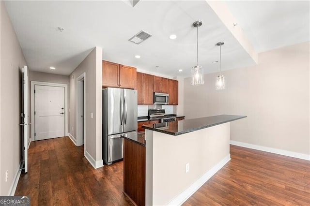 kitchen featuring decorative light fixtures, appliances with stainless steel finishes, dark hardwood / wood-style floors, and a kitchen island