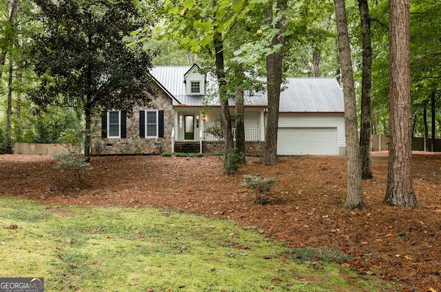 view of front of house featuring covered porch and a garage