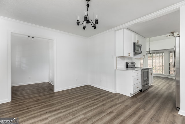 kitchen featuring crown molding, white cabinetry, stainless steel appliances, and dark hardwood / wood-style floors