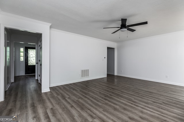 spare room with crown molding, dark wood-type flooring, a textured ceiling, and ceiling fan