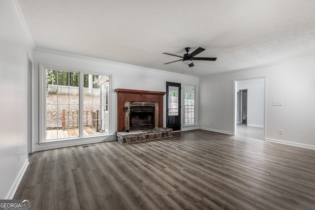 unfurnished living room with a fireplace, ornamental molding, a textured ceiling, ceiling fan, and dark hardwood / wood-style floors