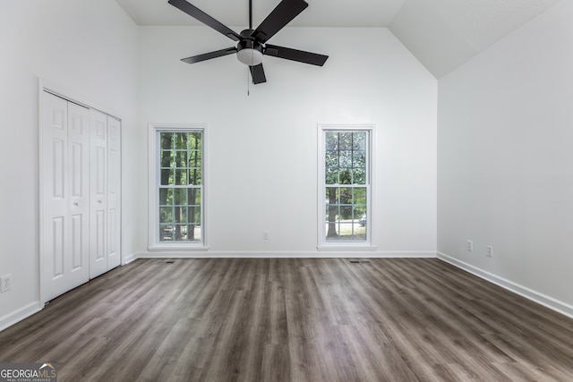 interior space with high vaulted ceiling, ceiling fan, and dark hardwood / wood-style flooring