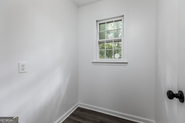 unfurnished room with dark hardwood / wood-style flooring