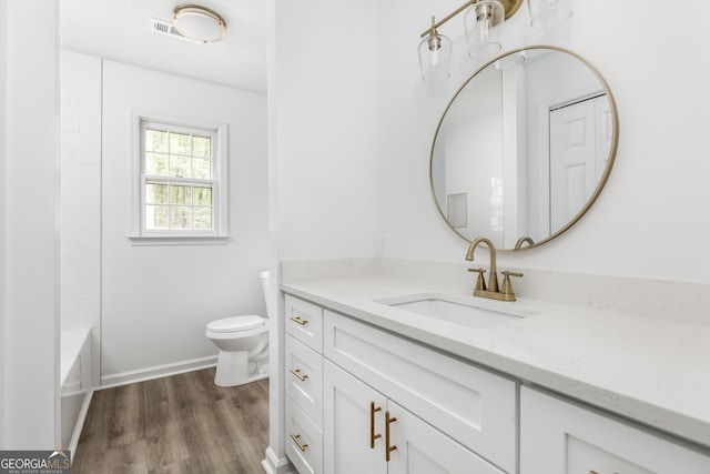 bathroom featuring vanity, toilet, and wood-type flooring