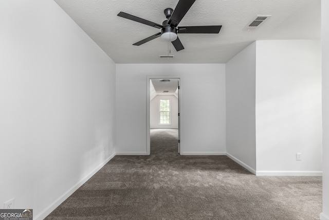 carpeted empty room featuring a textured ceiling and ceiling fan