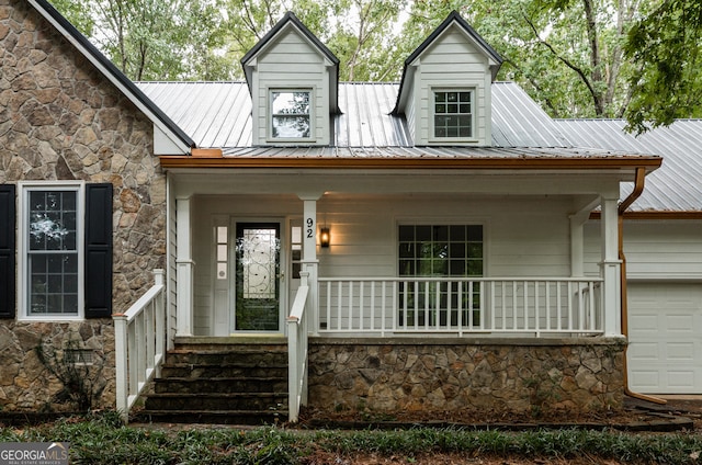 view of front of house featuring a garage and covered porch