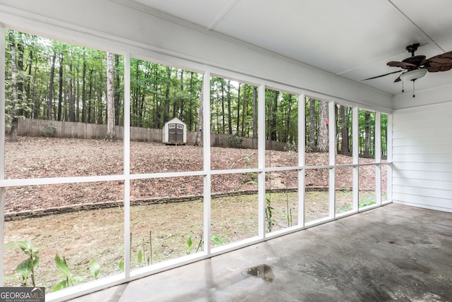 unfurnished sunroom featuring a healthy amount of sunlight and ceiling fan