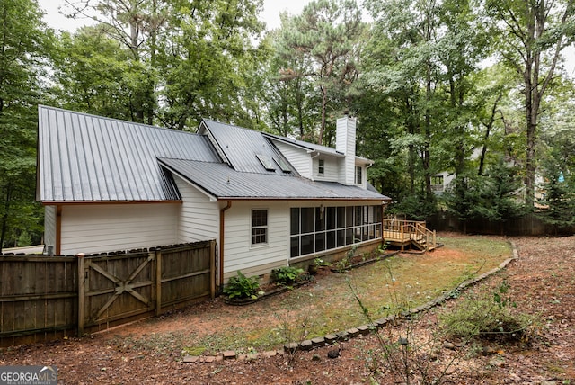 rear view of house with a wooden deck