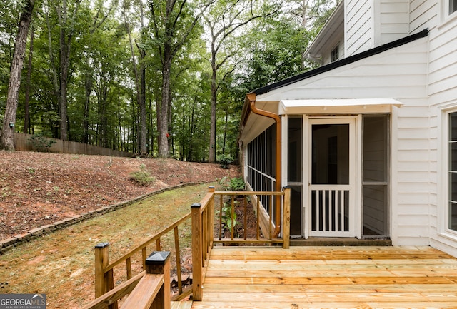 wooden deck with a sunroom