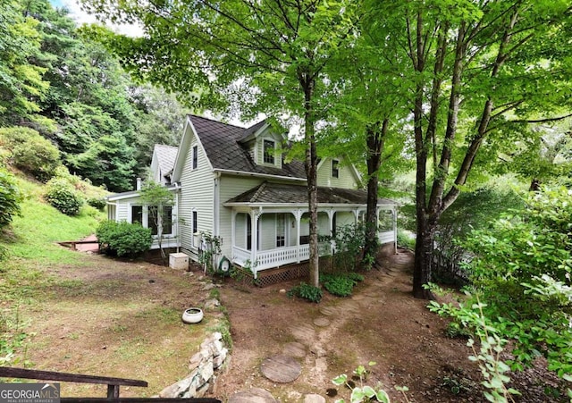 view of property exterior with covered porch