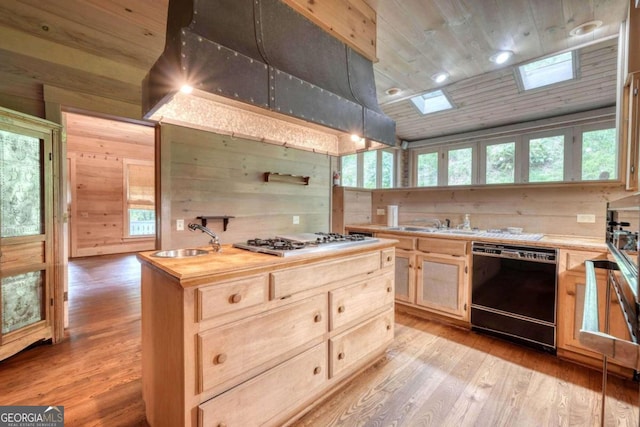 kitchen with butcher block countertops, light wood-type flooring, wooden walls, and dishwasher