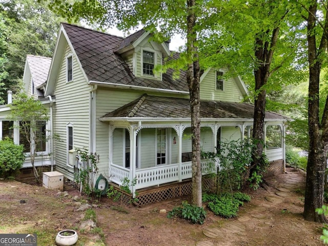 back of property featuring covered porch