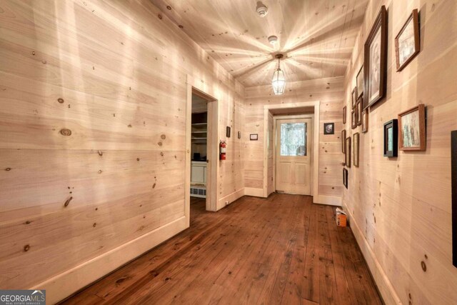 interior space featuring wooden walls and wood-type flooring