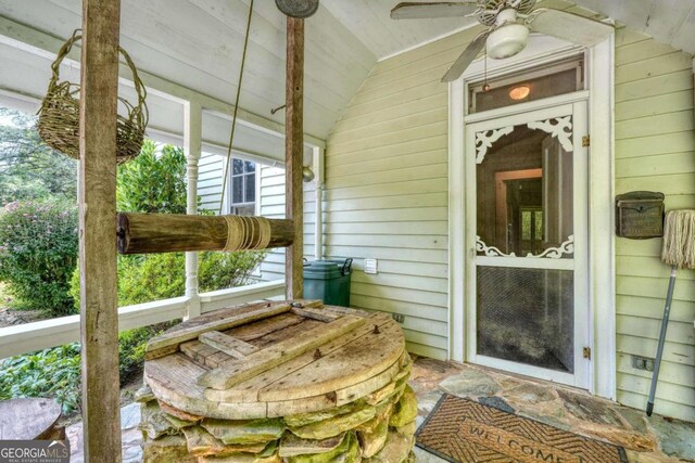 view of exterior entry featuring covered porch