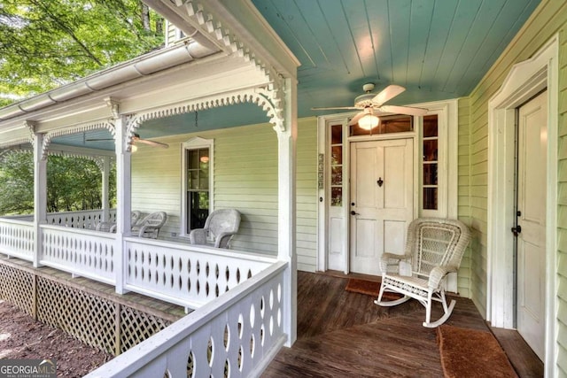 wooden deck featuring ceiling fan