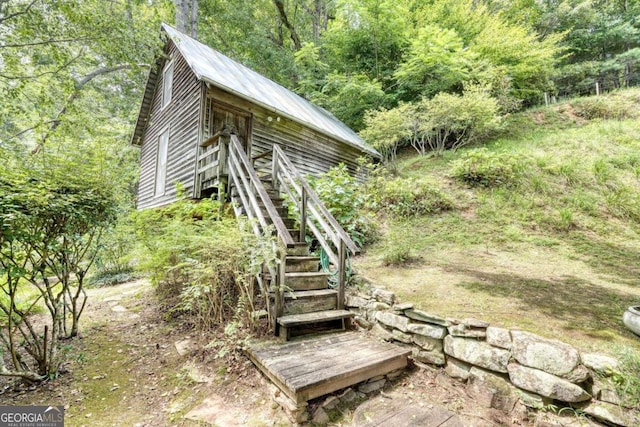 exterior space featuring stairway and a wooded view