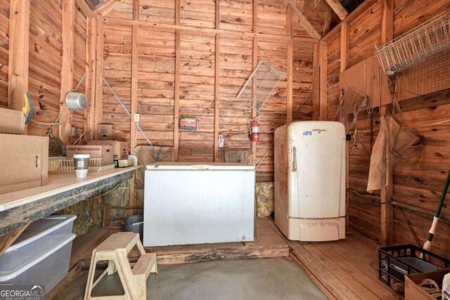 interior space featuring wood walls and water heater