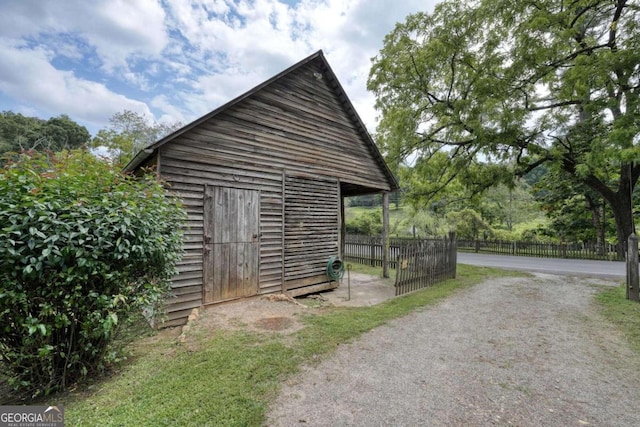 view of outdoor structure featuring an outdoor structure and fence