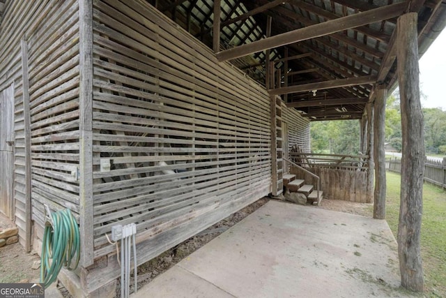 view of side of property with fence and a patio