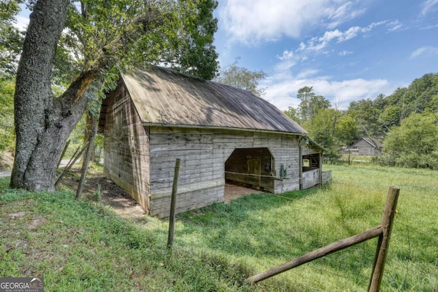 view of outdoor structure featuring a lawn