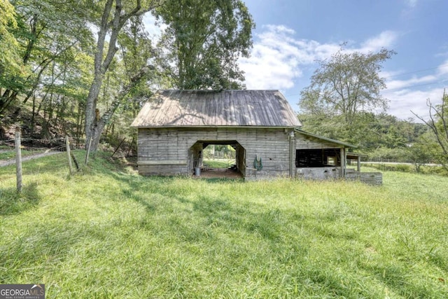 view of outdoor structure featuring a lawn