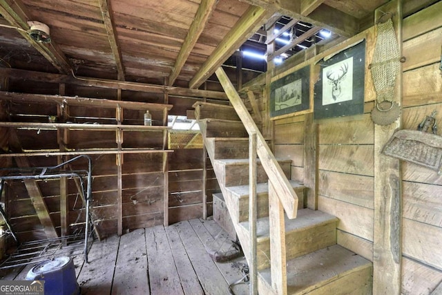 basement with wood walls, wood-type flooring, and wood ceiling