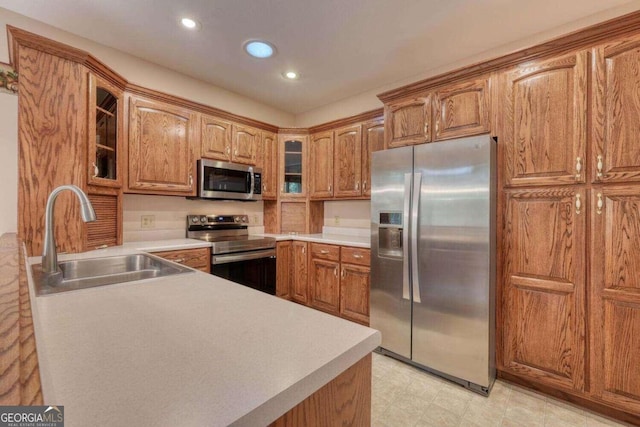 kitchen with sink, stainless steel appliances, and light tile patterned floors