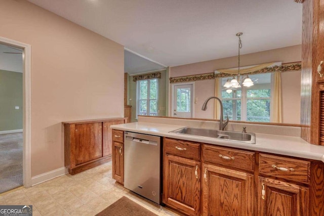 kitchen with light tile patterned flooring, sink, an inviting chandelier, stainless steel dishwasher, and hanging light fixtures