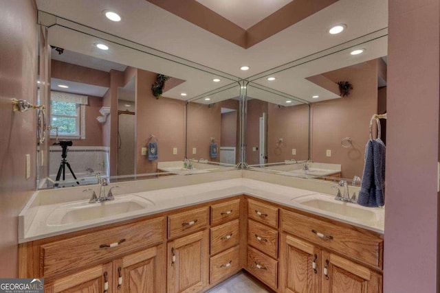 bathroom with a tub and vanity