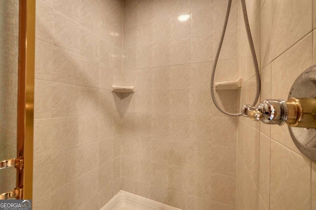 bathroom with tiled shower