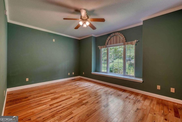 unfurnished room featuring ceiling fan, light wood-type flooring, a textured ceiling, and crown molding