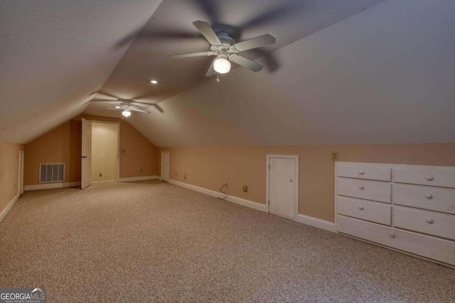 bonus room featuring ceiling fan, vaulted ceiling, and light colored carpet