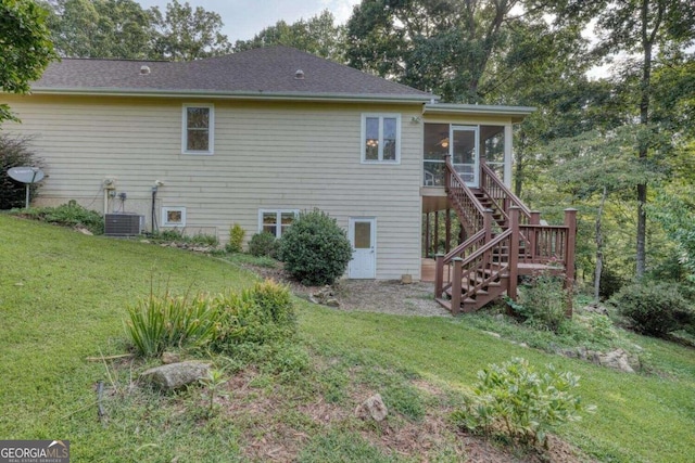 back of house with a sunroom, central AC unit, and a yard