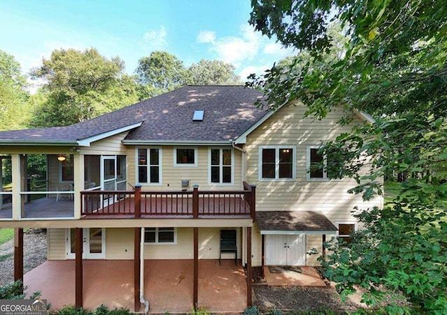 rear view of house featuring a patio and a deck