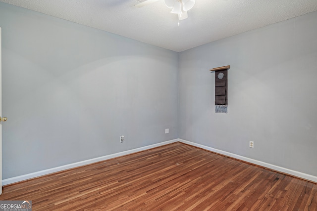 empty room featuring ceiling fan, a textured ceiling, and wood-type flooring