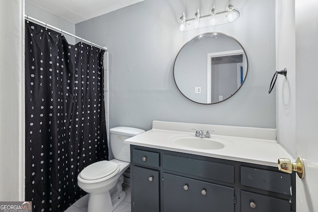 bathroom featuring a textured ceiling, tile patterned flooring, vanity, toilet, and walk in shower